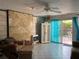 Comfortable living room features a sliding glass door to the backyard, tile flooring, and a ceiling fan at 21045 Lazy Days Cir, Lutz, FL 33558