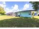 Expansive backyard with well-maintained lawn, a screened pool enclosure, and mature trees at 22348 Olean Blvd, Port Charlotte, FL 33952