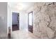 Inviting foyer with tile flooring, stone accent wall, and stylish front door at 22348 Olean Blvd, Port Charlotte, FL 33952