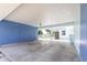 Carport featuring blue wood walls and a concrete floor at 22348 Olean Blvd, Port Charlotte, FL 33952