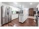 Updated kitchen with stainless steel appliances, an island, and sleek white cabinetry at 22348 Olean Blvd, Port Charlotte, FL 33952