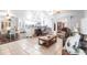 Open-concept living space with hardwood and tile flooring, connecting to a modern kitchen at 22348 Olean Blvd, Port Charlotte, FL 33952
