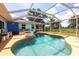 Beautiful pool with a screened enclosure, blue skies, and lush tropical landscaping at 22348 Olean Blvd, Port Charlotte, FL 33952