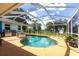 Sparkling pool surrounded by a screened enclosure and a seating area, perfect for outdoor enjoyment at 22348 Olean Blvd, Port Charlotte, FL 33952