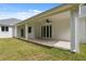 Expansive covered patio overlooking a well-maintained lawn, perfect for outdoor relaxation and entertaining at 2288 Rackley Rd, Brooksville, FL 34604