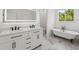 Elegant bathroom with clawfoot tub, double vanity, quartz counters and marble floors create a luxurious space at 2288 Rackley Rd, Brooksville, FL 34604