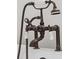 Close-up of the faucet of a clawfoot tub showing a telephone style faucet with porcelain knobs, and bronze finish at 2288 Rackley Rd, Brooksville, FL 34604