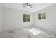 Bright bedroom with white marble floors, ceiling fan and large windows offering natural light at 2288 Rackley Rd, Brooksville, FL 34604
