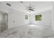 Spacious bedroom featuring marble floors, white walls, ample natural light through windows, and a ceiling fan at 2288 Rackley Rd, Brooksville, FL 34604