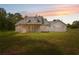 Beautiful white home with a spacious front yard and covered porch, perfect for enjoying sunsets at 2288 Rackley Rd, Brooksville, FL 34604