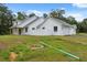 Charming single-story home featuring white exterior, grey roof, and attached garage at 2288 Rackley Rd, Brooksville, FL 34604