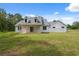 Charming white home featuring a covered front porch and a well-maintained lawn at 2288 Rackley Rd, Brooksville, FL 34604