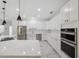 Bright, open kitchen with white cabinets, stainless steel appliances, and a large island at 2288 Rackley Rd, Brooksville, FL 34604