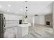 Bright, open kitchen with white cabinets, stainless steel appliances, a large island, and fireplace at 2288 Rackley Rd, Brooksville, FL 34604