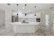 Bright, open kitchen with white cabinets, stainless steel appliances, and a large island with a cooktop at 2288 Rackley Rd, Brooksville, FL 34604