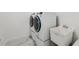 Modern laundry area featuring a front-load washer/dryer set with a utility sink for added convenience at 2288 Rackley Rd, Brooksville, FL 34604