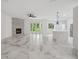 Open-concept living room showcasing marble floors, a fireplace, and a modern kitchen at 2288 Rackley Rd, Brooksville, FL 34604