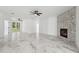 Open living area featuring marble floors, stone fireplace, and access to an outdoor view at 2288 Rackley Rd, Brooksville, FL 34604