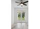 Bright living space with marble floors and access to a covered patio and view of the yard at 2288 Rackley Rd, Brooksville, FL 34604