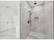 Walk-in shower featuring dual shower heads, marble walls, and modern fixtures, creating a spa-like experience at 2288 Rackley Rd, Brooksville, FL 34604
