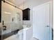 Modern bathroom with a glass-enclosed shower, sleek fixtures, and efficient storage at 2326 Mountain Ash Way, New Port Richey, FL 34655