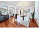 Elegant dining room with a modern chandelier, large mirror, and hardwood flooring at 2326 Mountain Ash Way, New Port Richey, FL 34655
