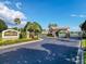 Magnolia Estates entrance featuring a stone sign, well-maintained landscaping, and a charming gatehouse, adding to the community's appeal at 2326 Mountain Ash Way, New Port Richey, FL 34655