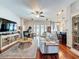 Inviting living room featuring hardwood floors, a ceiling fan, and an open-concept layout at 2326 Mountain Ash Way, New Port Richey, FL 34655