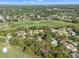 Picturesque community aerial showcasing the golf course, lush greenery, and homes nestled among mature trees at 2342 Countryside Dr, Spring Hill, FL 34606