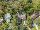 Birds eye view of property surrounded by lush green trees and a well maintained landscape at 2342 Countryside Dr, Spring Hill, FL 34606