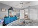 Bright bedroom features blue decor, carpet flooring, and plenty of natural light at 2342 Countryside Dr, Spring Hill, FL 34606