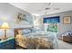 Comfortable bedroom with neutral colors, ceiling fan and natural light from the window at 2342 Countryside Dr, Spring Hill, FL 34606