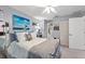 Bedroom with neutral walls, ceiling fan, walk-in closet, carpet flooring, and access to bathroom at 2342 Countryside Dr, Spring Hill, FL 34606