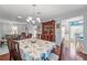 Dining area featuring a seashell-themed table set and hardwood floors at 2342 Countryside Dr, Spring Hill, FL 34606