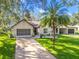 Charming single-story home featuring a well-manicured lawn, two-car garage and covered carport at 2342 Countryside Dr, Spring Hill, FL 34606