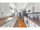 Updated kitchen with granite countertops, white cabinets, and modern appliances at 2342 Countryside Dr, Spring Hill, FL 34606