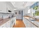 Bright kitchen featuring white cabinets and granite countertops at 2342 Countryside Dr, Spring Hill, FL 34606