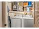 Convenient laundry room with washer, dryer, water heater, shelving, and storage space at 2342 Countryside Dr, Spring Hill, FL 34606
