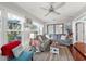 Bright living room with a cozy sectional sofa, ceiling fan, and view to the outdoors at 2342 Countryside Dr, Spring Hill, FL 34606
