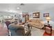 Open living room showcasing a comfortable seating arrangement and connection to dining area at 2342 Countryside Dr, Spring Hill, FL 34606