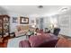 Inviting living room featuring a comfortable sofa, hardwood floors and display cabinet at 2342 Countryside Dr, Spring Hill, FL 34606