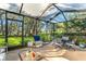 Screened in patio with outdoor seating, beautiful landscaping and views at 2342 Countryside Dr, Spring Hill, FL 34606