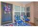 Cozy front porch with seating, patriotic decor, and a welcoming atmosphere at 2342 Countryside Dr, Spring Hill, FL 34606