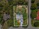 Aerial view of property highlighting backyard pool, mature landscaping, and proximity to neighboring houses at 2404 Knoll Dr, Spring Hill, FL 34608