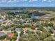 Beautiful aerial view capturing a tranquil neighborhood, serene pond, and lush greenery under a partly cloudy sky at 2404 Knoll Dr, Spring Hill, FL 34608
