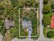 Aerial view of property highlighting backyard pool, mature landscaping, and proximity to neighboring houses at 2404 Knoll Dr, Spring Hill, FL 34608