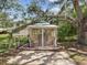 Cozy backyard gazebo with comfortable seating, perfect for relaxing and entertaining guests outdoors at 2404 Knoll Dr, Spring Hill, FL 34608