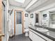 Contemporary bathroom featuring dark floors, granite countertop, updated vanity, and a skylight at 2404 Knoll Dr, Spring Hill, FL 34608