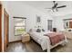 Bedroom with a ceiling fan, wood flooring, and a large window, offering lots of natural light at 2404 Knoll Dr, Spring Hill, FL 34608