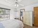 Inviting bedroom with neutral tones, a ceiling fan, and large window with natural light at 2404 Knoll Dr, Spring Hill, FL 34608